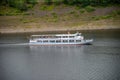 Agrement passanger boat cruising on a natural lake between mountains on a summar day