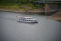 Agrement passanger boat cruising on a natural lake between mountains on a summar day