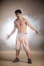 Agressive confident Asian man with dark skin standing nacked to the waist