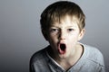 An agressive little boy shouts Royalty Free Stock Photo