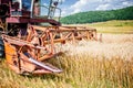 Agricultural activities with vintage harvesting machine Royalty Free Stock Photo