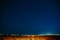 Agricultural Colorful Background Copy Space. Night Starry Sky Above Rural Landscape Field Meadow With Rolls Of Straw In Royalty Free Stock Photo