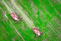 Agricultural combine harvesters on green cultivated field on harvest time. Aerial view on harvester. Agriculture