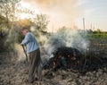 Work in the garden. Farmer burning dried branches