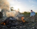 Work in the garden. Farmer burning dried branches