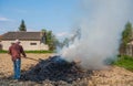 Work in the garden. Farmer burning dried branches