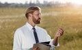 Agricultural engineer holding examining plant Royalty Free Stock Photo