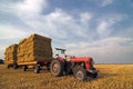 Agricultural Equipment red tractor with straw on t Royalty Free Stock Photo