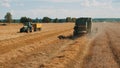 Agricultural Farm Field With Two Big Tractors During The Daytime - Harvesting Concept