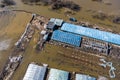 Agricultural farm with greenhouses in a field flooded during a strong spring flood as a result of a river flood Royalty Free Stock Photo