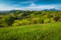 Agricultural farmland and green fields with snowy mountains, Holbav, Romania Royalty Free Stock Photo