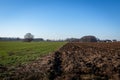 Agricultural field with bare soil in wintertime in Poland. Royalty Free Stock Photo