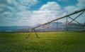 Agricultural irrigation system watering a green wheat field Royalty Free Stock Photo