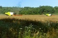 Two agricultural machines operate in the field, grain harvesting machines operate in the field, agricultural land Royalty Free Stock Photo