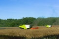 Two agricultural machines operate in the field, grain harvesting machines operate in the field, agricultural land Royalty Free Stock Photo