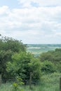 An agricultural landscape of distant cultivated fields and trees and blue sky in Yorksh ire England Royalty Free Stock Photo