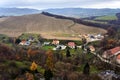 Agricultural landscape with houses, hill and forest Royalty Free Stock Photo