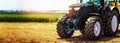 agricultural machinery farm equipment - tractor standing on the field. banner Royalty Free Stock Photo