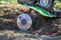 Small green plowing machine in hands of a farmer, tillage equipment, agricultural machine, agriculture, making arable in soil