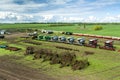 Agricultural machinery, Tractor and farmer in agricultural fields of wheat and rapeseed