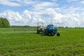 Agricultural machinery, Tractor and farmer in agricultural fields of wheat and rapeseed Royalty Free Stock Photo