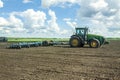 Agricultural machinery, Tractor and farmer in agricultural fields of wheat and rapeseed Royalty Free Stock Photo