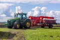 Agricultural machinery, Tractor and farmer in agricultural fields of wheat and rapeseed