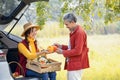 agricultural product middleman talking and checking the quality of the fruit before deciding to buy from a young woman Royalty Free Stock Photo