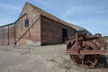 Agricultural shed building and vintage farm machinery in rural N Royalty Free Stock Photo