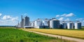 Agricultural Silos - Building Exterior, Storage and drying of grains, wheat, corn, soy, sunflower against the blue sky with rice Royalty Free Stock Photo
