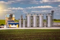 Agricultural Silos. Storage and drying of grains, wheat, corn, soy, sunflower against the blue sky with white clouds.Storage of Royalty Free Stock Photo