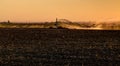 An agricultural center pivot sprinkler, irrigating at sunset. Royalty Free Stock Photo