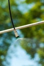 Agricultural sprinkler spraying the water drops over crops in cultivated field during the drought season