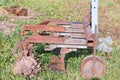 Agricultural tool, old rusty plow for tractor lying in the field Royalty Free Stock Photo