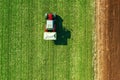 Agricultural tractor fertilizing wheat crop field with NPK Royalty Free Stock Photo