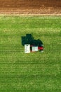 Agricultural tractor fertilizing wheat crop field with NPK Royalty Free Stock Photo