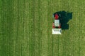 Agricultural tractor fertilizing wheat crop field with NPK Royalty Free Stock Photo