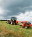 An agricultural tractor with a mower