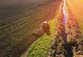 Agricultural Tractor with Plough on Plowed Field. Tractor with disc Cultivator on Cultivating field. Soil Tillage and Sowing Seeds