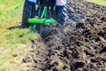 An agricultural tractor plowing a field is cultivating soil at preparation for planting of grain in spring Royalty Free Stock Photo