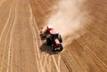 Agricultural tractor sowing seed onto at field. Farming and seeding concept. Seeds sowing in farmers country. Planting Equipment Royalty Free Stock Photo