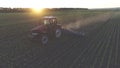 Agricultural tractor in the spring field on the sunset Royalty Free Stock Photo