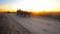 Agricultural tractor transporting harvested crops on rural road