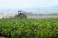 Agricultural work of tractor plowing in a soy field in broad daylight