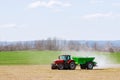 Skutc, Czech Republic - March 23 2020: Tractor spreading fertilizer on grass field. Agricultural work