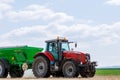 Skutc, Czech Republic - March 23 2020: Tractor spreading fertilizer on grass field. Agricultural work