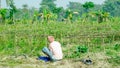 A farmer eating lunch at his field.