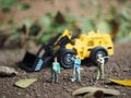 Agriculture and cultivating conceptual design. Miniature toy of Farmer with blurred tractor on the field. Royalty Free Stock Photo