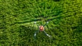 Agriculture drone flying and spraying fertilizer and pesticide over farmland,High technology innovations and smart farming. aerial