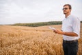 Agriculture, farmer or agronomist inspect quality of wheat in field ready to harvest